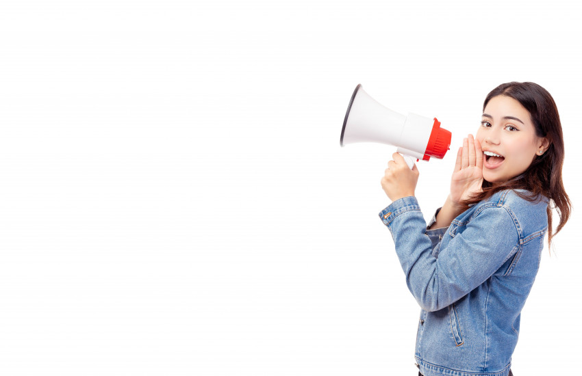 Smiling girl talking in megaphone